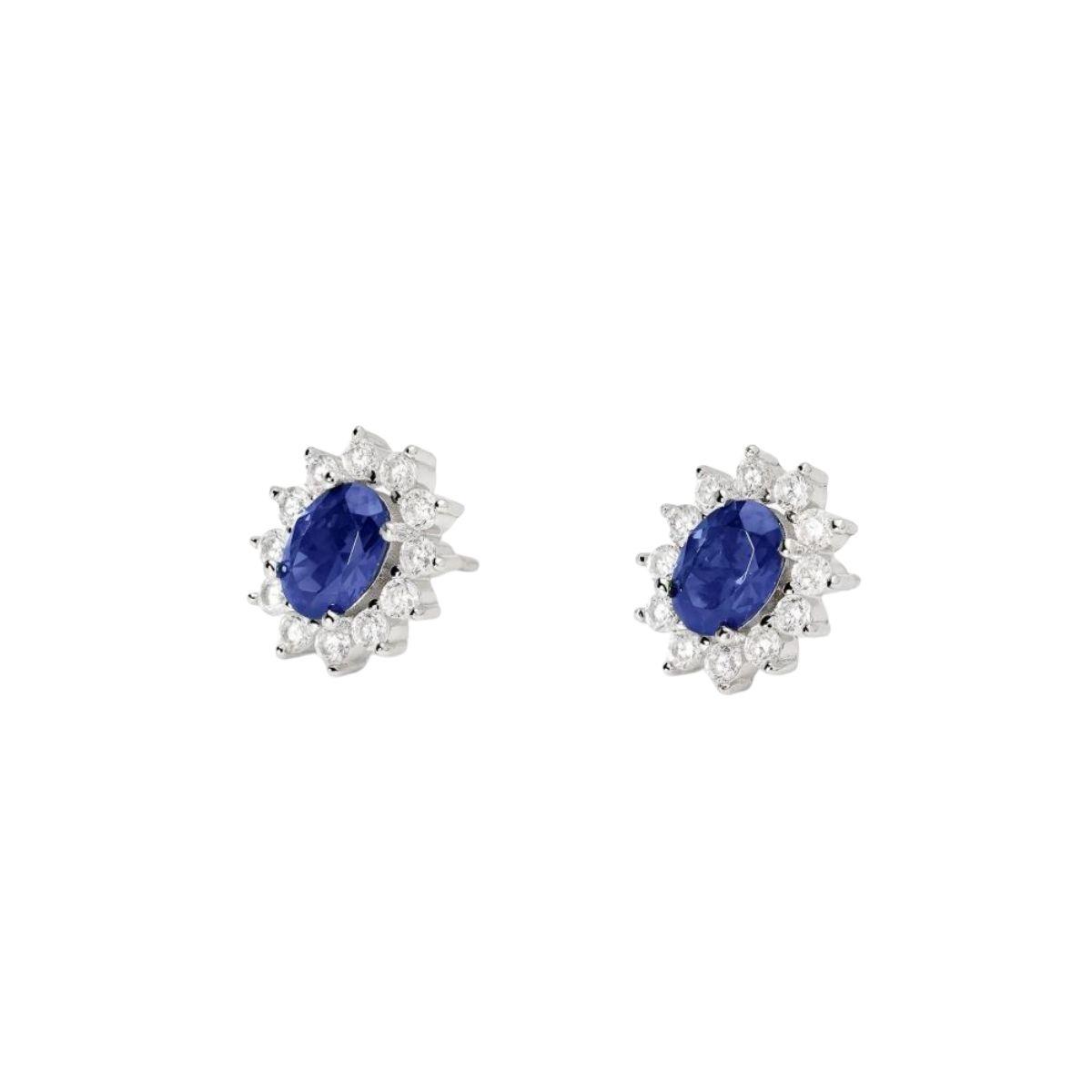 Mabina silver earrings featuring an oval synthetic blue sapphire and surrounding white cubic zirconia.